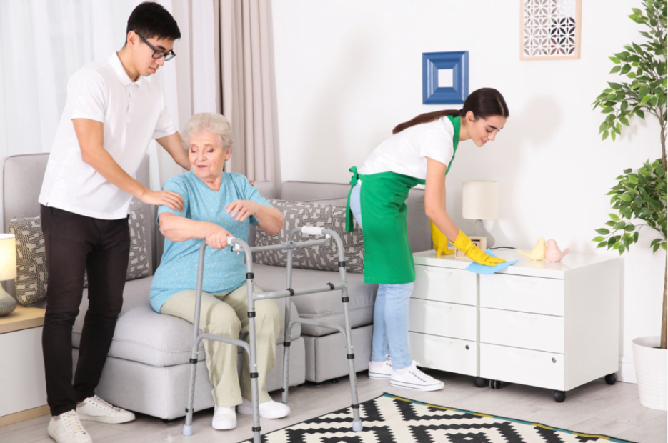 Elderly woman with a walker receiving personal support from a male caregiver,